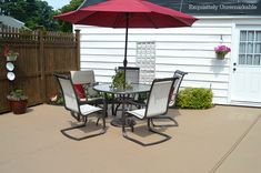 a patio table and chairs with an umbrella