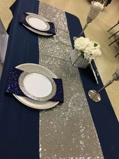 the table is set with silver and blue sequins