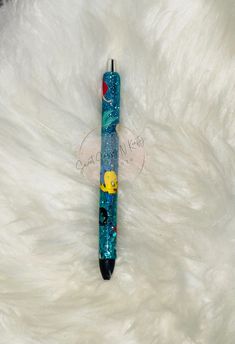 a blue pen sitting on top of a white fur covered floor