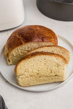 two loaves of bread on a white plate