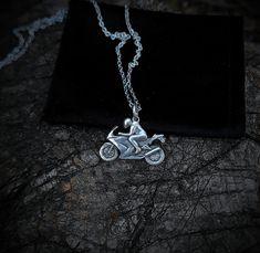 A tiny silver pendant depiction of a riding sports bike, full 3d sculpted and cast into solid metal. This is an excellent gift for anyone who's into sports bikes, or a biker in general. Get them this tiny piece of jewelry and watch the smile unveiled on their face when they see it. The pendant is cast as a single piece of silver, no welding or solder was used so the piece is very strong and durable. The chain is hand woven out of wire and every link is welded shut so no easy braking of the chain Silver Stainless Steel Biker Jewelry, Biker Style Stainless Steel Jewelry For Biker Events, Biker Style Sterling Silver Jewelry For Biker Events, Silver Stainless Steel Jewelry For Biker Events, Silver Biker Jewelry As A Gift, Silver Engraved Jewelry For Biker Events, Silver Motorcycle, Bike Jewelry, Sports Bike