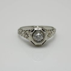 an antique style engagement ring with three diamonds