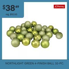 a pile of green christmas balls sitting next to each other