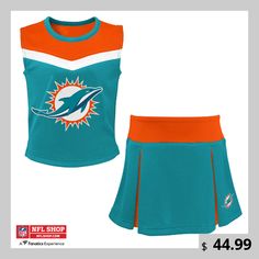 Your young Miami Dolphins fan can help lead the team to victory with this Spirit two-piece cheerleader set. Its colorful design will help them feel like they're out on the field bringing the crowd to its feet in support of the Miami Dolphins. The fabric is soft yet strong, allowing your aspiring cheerleader to jump, dance and cheer with confidence. Young Miami, Jump Dance, Cheer Tops, Gameday Fits, Cheer Captain, Cheerleader Costume, Dolphin Shorts, Uniform Design, Shield Design