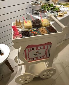 an ice cream cart filled with lots of different types of desserts and candies