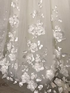 white flowers are on the sheer fabric