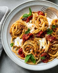 a white plate topped with pasta and sauce