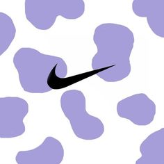 a black nike logo on a purple and white cow print wallpaper with the word nike above it