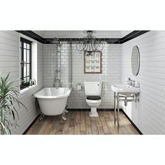 a bathroom with a tub, toilet and sink in it's center piece is shown