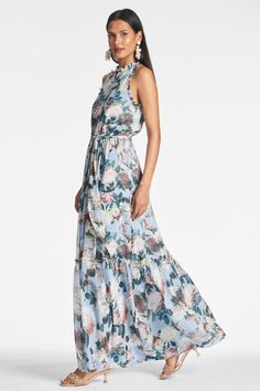 Blair is a perennial maxi silhouette. A shirt style bodice has functional buttons to the waist, a self-tie sash and lovely tiers to the hem.Details:Model is 5'11" Wearing A Size 254" LongFront Button ClosurePrinted Chiffon 100% Viscose ImportedStyle #F231D04-452 Spring Blue Maxi Dress With Tie Waist, Blue Maxi Dress With Tie Waist For Spring, Flowy Maxi Dress With Tie Waist For Garden Party, Tiered Floral Print Maxi Dress For Garden Party, Tiered Floral Print Maxi Dress For Daywear, Floral Print Tiered Maxi Dress For Garden Party, Tiered Maxi Dress With Floral Print For Daywear, Daywear Floral Print Tiered Maxi Dress, Floral Print Tiered Maxi Dress For Daywear