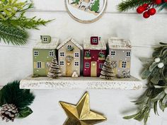 christmas decorations and ornaments on a shelf in front of a white wall with a clock