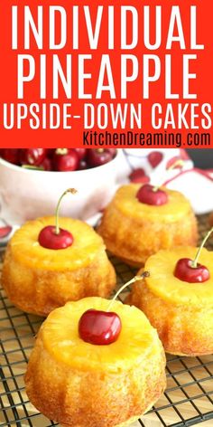 individual pineapple upside down cakes on a cooling rack with cherries in the background