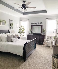 a bedroom with a bed, dresser and ceiling fan in it's center area