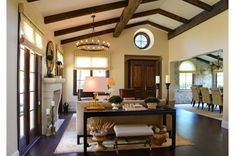 a living room filled with furniture and a fire place in the middle of a room