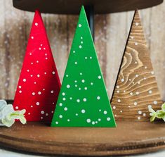 three wooden christmas trees sitting on top of a table