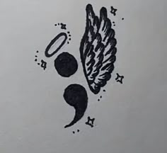 a drawing of an angel wing and two circles with stars around it on a piece of paper