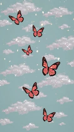 several pink butterflies flying through the sky