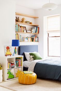 a child's bedroom with bookshelves and toys