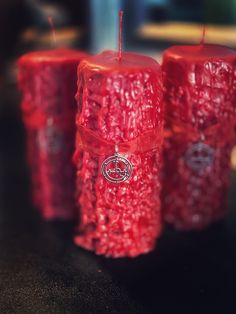 three red candles sitting next to each other on a table