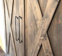 the door is made out of wood and has metal handles