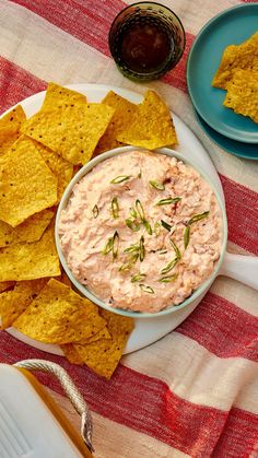 a bowl of dip surrounded by tortilla chips