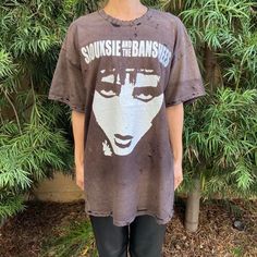 a woman standing in front of a bush wearing a t - shirt with the words, sunshine is thebanser on it