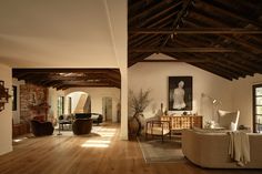 a living room filled with furniture next to a wooden floor covered in lots of windows