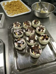 there are many desserts on the tray ready to be eaten and served in the kitchen