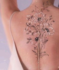 the back of a woman's body with flowers on it