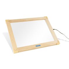 a wooden frame holding a mirror on a white surface with a cord attached to it