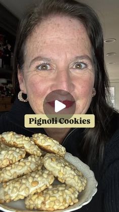 a woman making a funny face while holding a plate with cookies in front of her