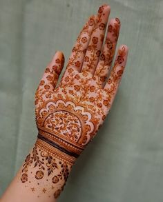 a woman's hand with henna on it