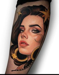 a woman's face with stars and crescents on her leg, done by tattoo artist