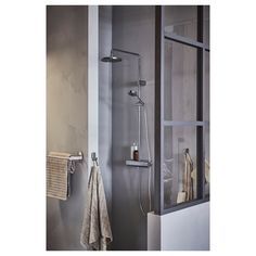 a bathroom with a shower and towel rack