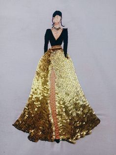 a woman wearing a gold and black dress with sequins on the skirt is standing in front of a white backdrop