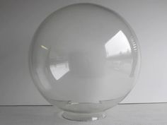 a clear glass ball sitting on top of a table