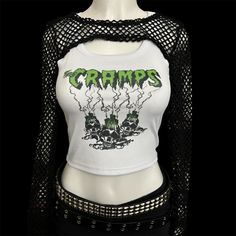 * Sublimated green psychobilly horror punk band cropped tank top * Mannequin is wearing size S * Mannequin measurements:    * Bust: 35" (C cup)    * Waist: 26"    * Hip: 40" * Soft, breathable, and stretchy material * For a looser fit, size up * Please note that all items are Made to Order & there may be slight variations in appearance Y2k Style Green Crop Top For Streetwear, Punk Crop Top For Festivals, Punk Style Crop Top For Festival, Punk Crop Top For Halloween, Y2k Tank Top For Spring Alternative Fashion, Spring Y2k Tank Top For Alternative Fashion, Y2k Style Tank Top For Spring Alternative Fashion, Emo Fitted Crop Top For Halloween, Edgy Halloween Vest For Alternative Fashion