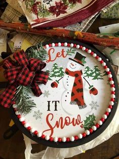 a decorated tray with a snowman on it and the words let it snow written in red