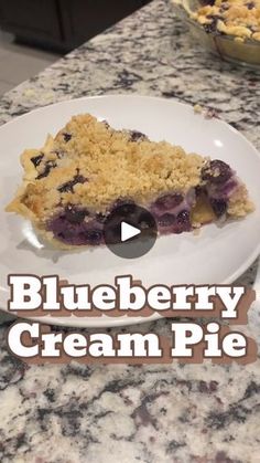 a blueberry cream pie on a white plate with the words blueberry cream pie