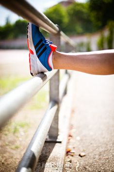 a person's foot on the edge of a rail