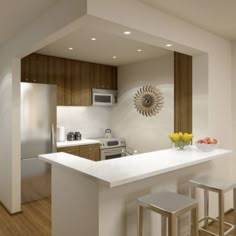 a modern kitchen with white counter tops and wooden cabinets, along with stainless steel appliances