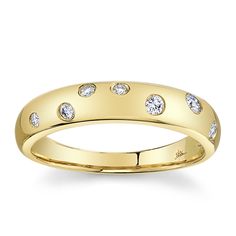 a yellow gold wedding ring with five diamonds