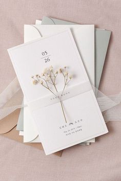 the wedding card is laying on top of some other greetings cards and envelopes