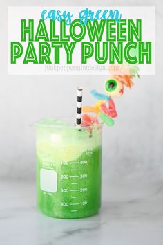 a green halloween party punch in a measuring cup