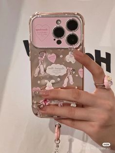 a woman's hand holding an iphone case with bunny and hearts on it