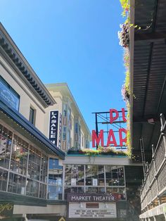 the sign for pike mall is hanging from the side of the building above the market