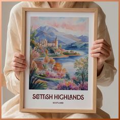 a woman holding up a painting with the words scottish highlands