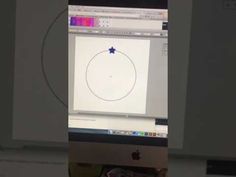 an apple computer monitor with a drawing on it's screen and the image of a circle