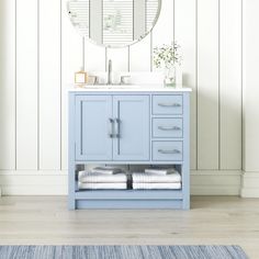 a bathroom with a blue vanity and white walls