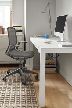 an office chair sitting in front of a desk with a computer on top of it